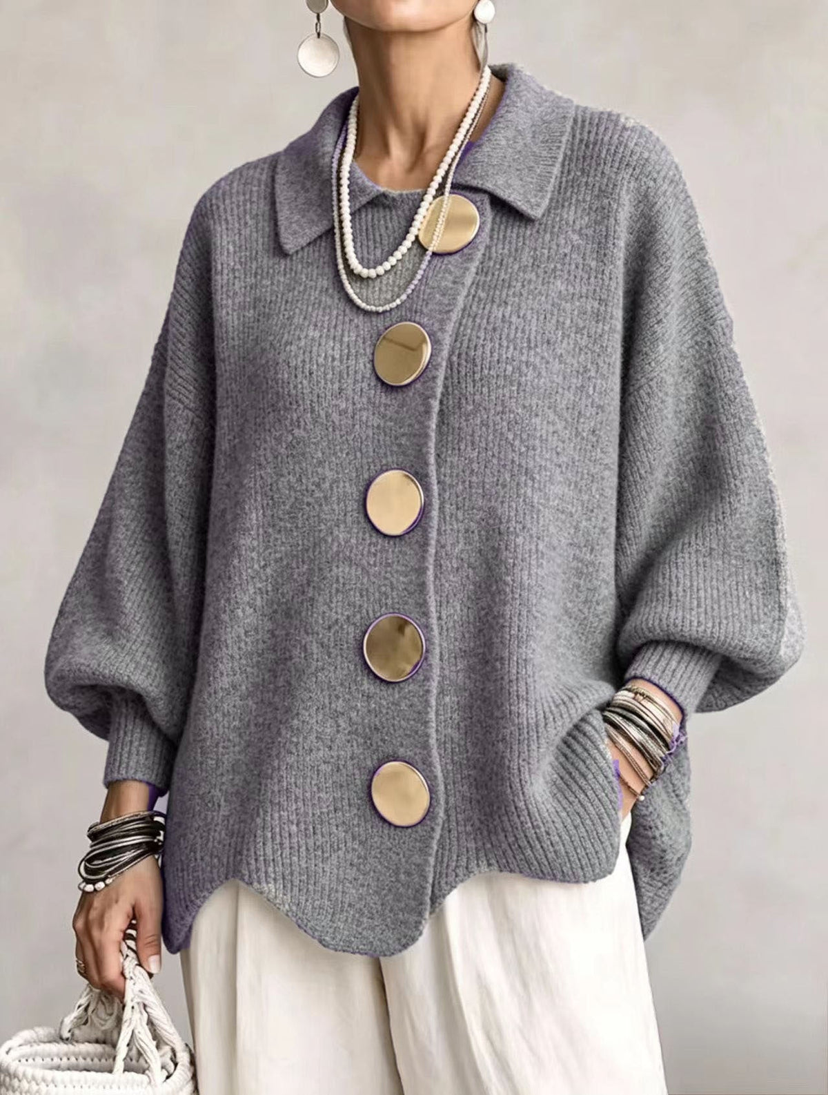 Gray oversized button-front cardigan with a structured pointed collar, softly voluminous sleeves, and curved hem.