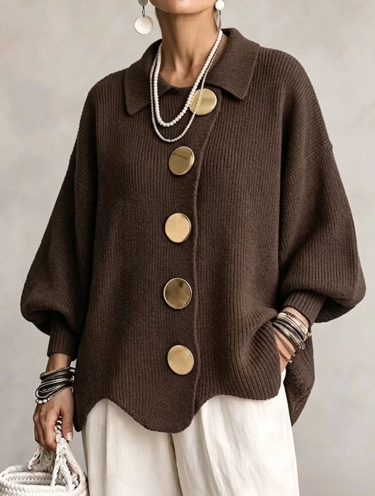Dark brown oversized cardigan styled with a five-button front, pointed collar, ribbed cuffs, and a curved hemline.