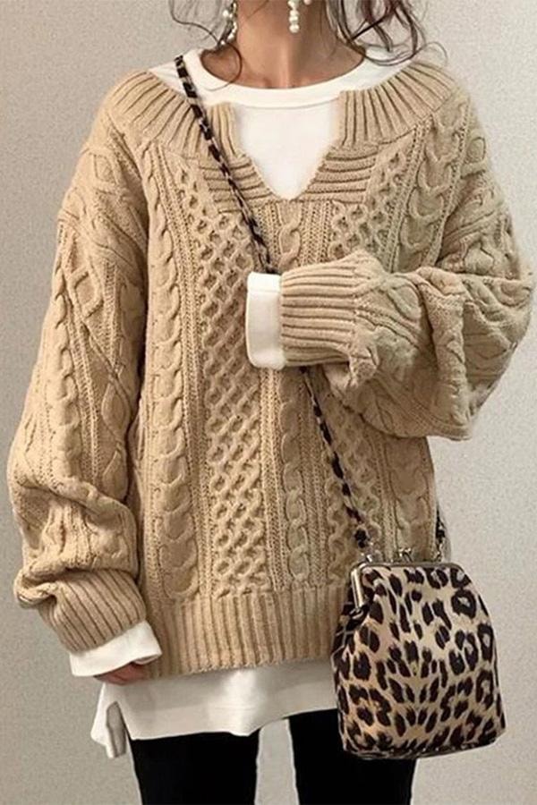 Beige longline cable knit sweater with a relaxed oversized fit, V-neck, and extended ribbed cuffs.