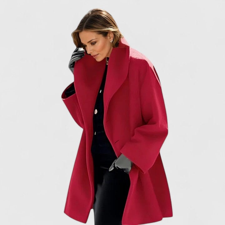 Red oversized coat featuring a dramatic wide lapel collar and relaxed long sleeves, worn open.