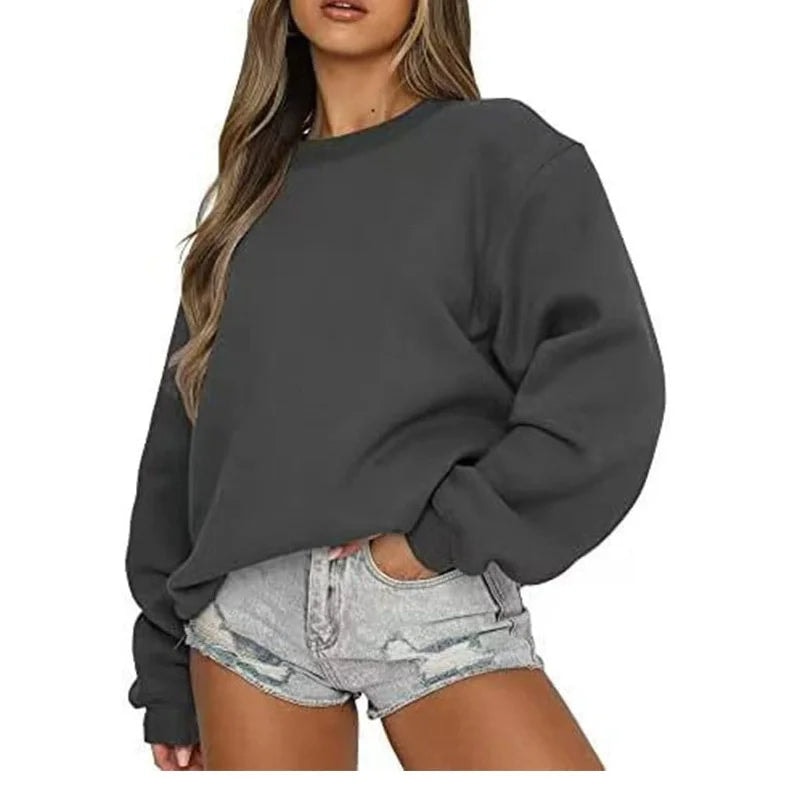 Charcoal gray oversized crew neck sweatshirt modeled from the front, with dropped shoulders and a relaxed lower hem.