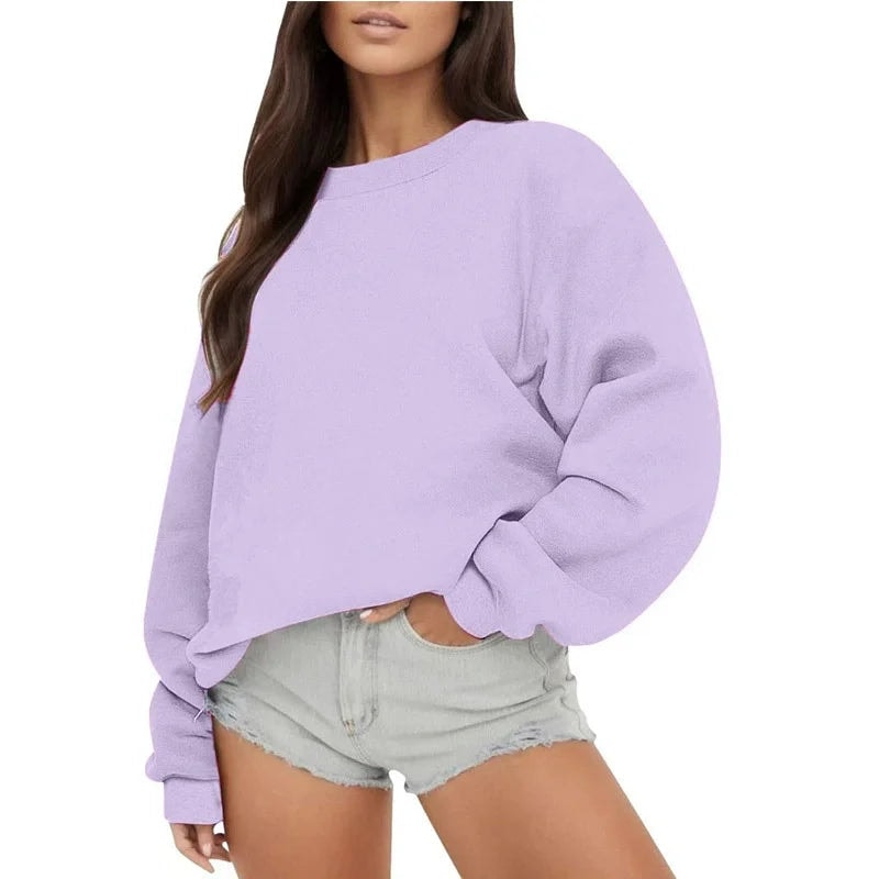 Lavender oversized crew neck sweatshirt on a model, featuring dropped shoulders, long sleeves, and gathered ribbed cuffs.