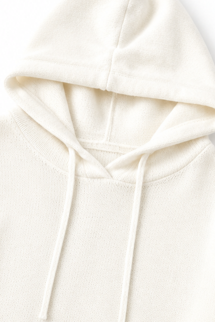 Close-up of the ivory sweater hood with long adjustable drawstrings and a softly structured neckline.