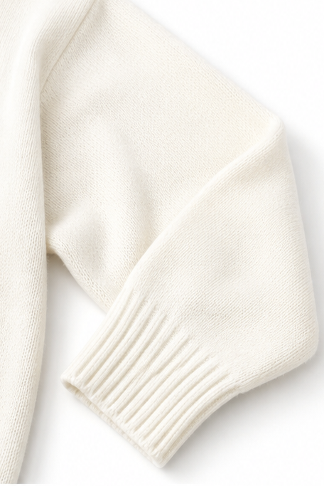 Close-up of the sweater sleeve ending in a wide ribbed cuff.