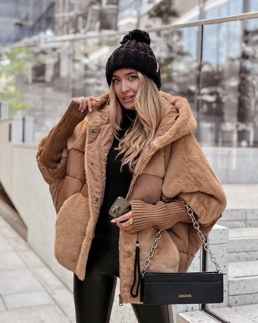 Camel oversized hooded puffer jacket with plush panels, ribbed cuffs, and front closures styled for a city outfit.
