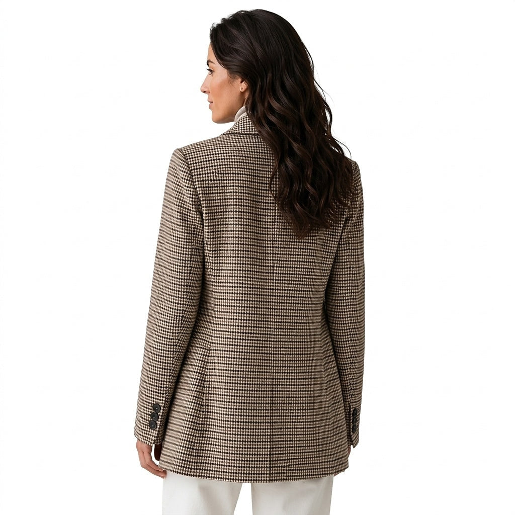 Back view showing the blazer’s continuous houndstooth pattern, structured shoulders, long sleeves, and longer relaxed hem.