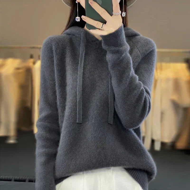 Charcoal-gray oversized knit hoodie with a relaxed pullover shape, hood, drawstrings, and ribbed cuffs.