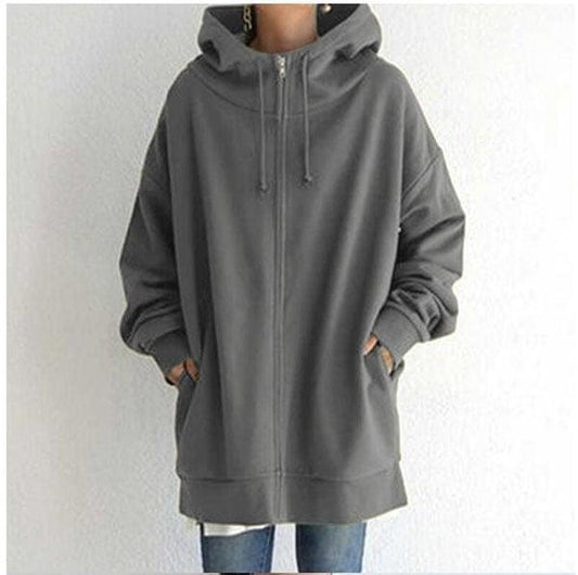 Front view of a charcoal oversized longline zip-up hoodie with drawstring hood, high neckline, and two side pockets.