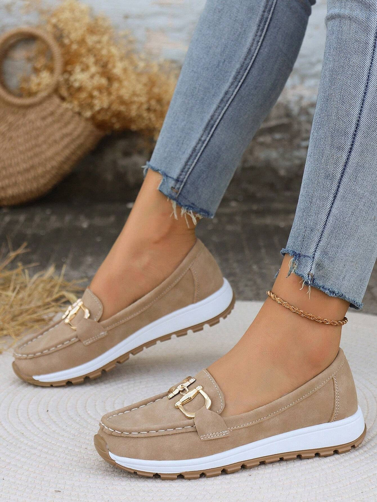 Beige platform loafers shown in profile with gold-tone buckle detailing, rounded stitched toes, and rugged textured outsoles.
