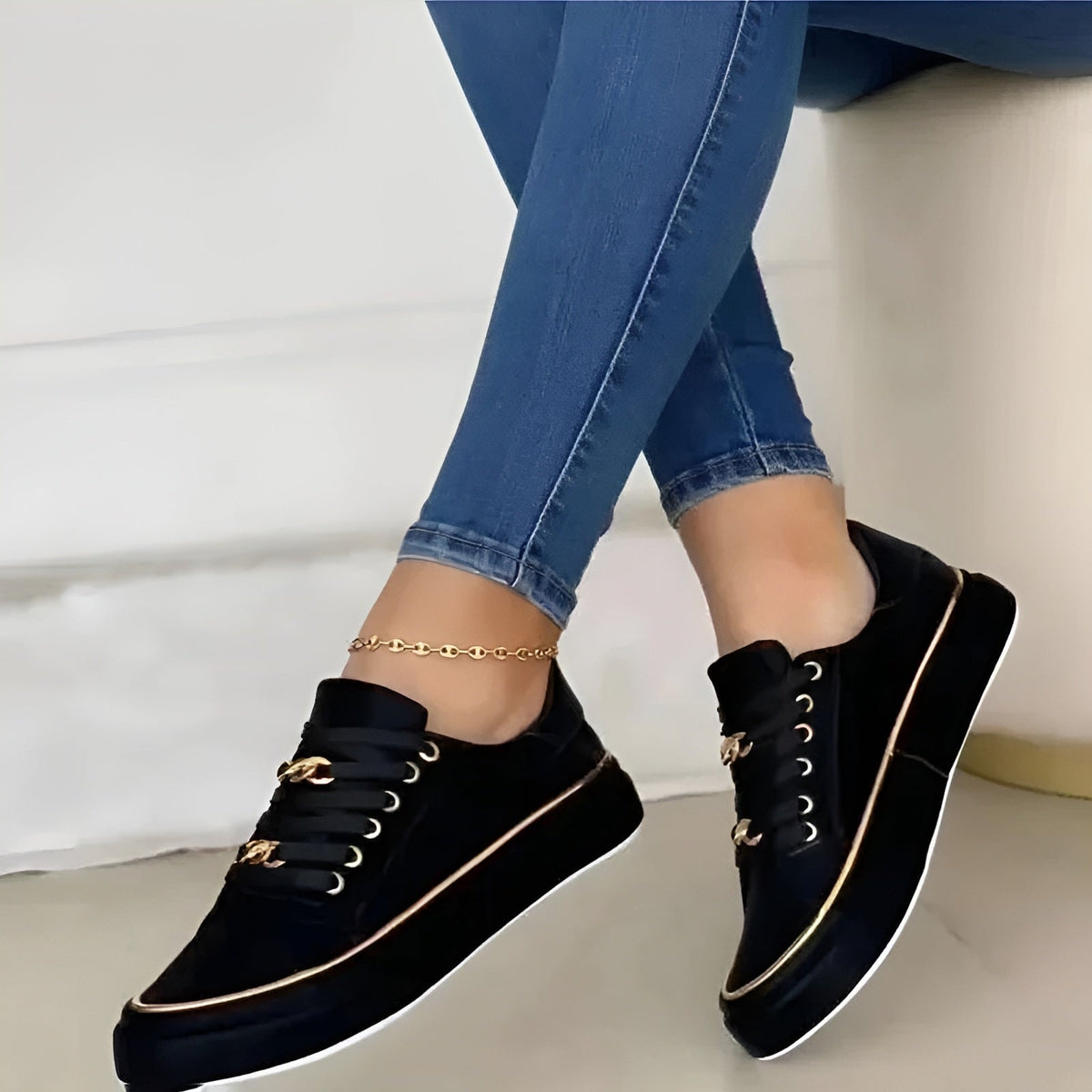 Black lace-up platform sneakers viewed at an angle, emphasizing the thick raised soles, rounded toes, and slim metallic side trim.