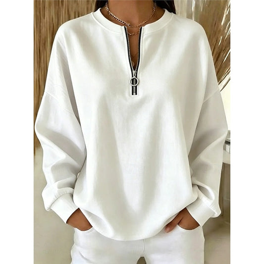 White relaxed sweatshirt with a quarter-zip high neckline, dropped shoulders, long sleeves, and fitted cuffs.