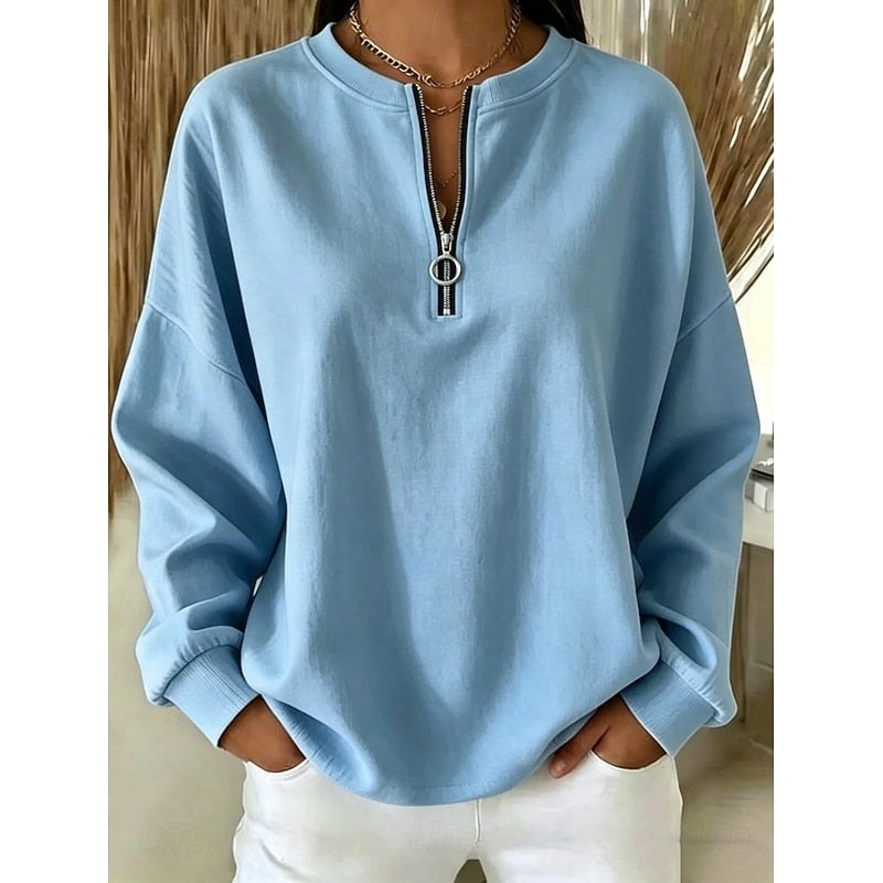 Light blue quarter-zip sweatshirt shown in a relaxed fit with dropped shoulders and ribbed sleeve cuffs.