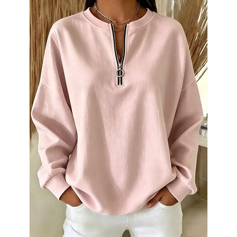 Soft pink relaxed sweatshirt with a quarter-zip neckline, curved hem, and fitted cuffs.