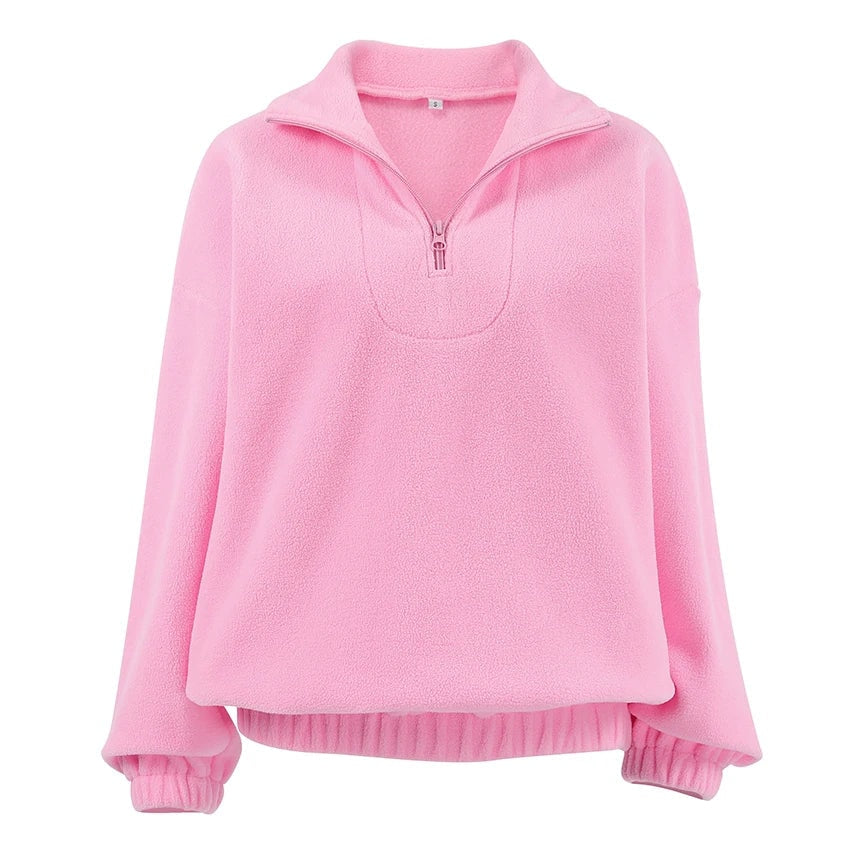 Pink quarter-zip sweatshirt shown from the front with a folded stand collar, long sleeves, ribbed cuffs, and ribbed hem.
