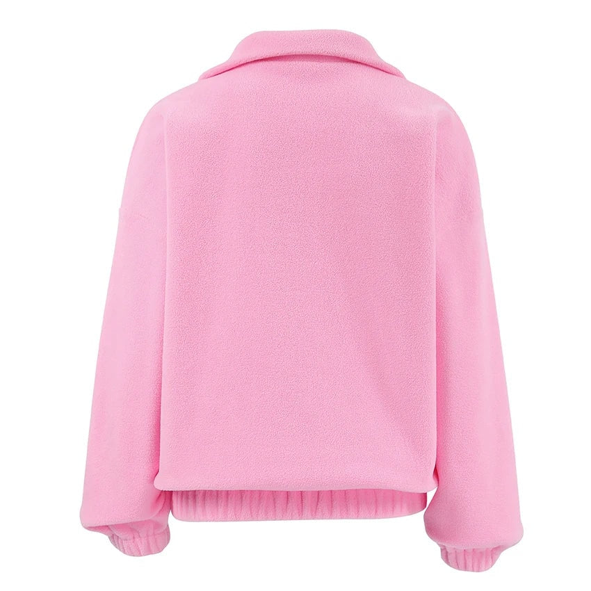Back view of the pink sweatshirt showing its relaxed shape, long sleeves, stand collar, and ribbed hem.