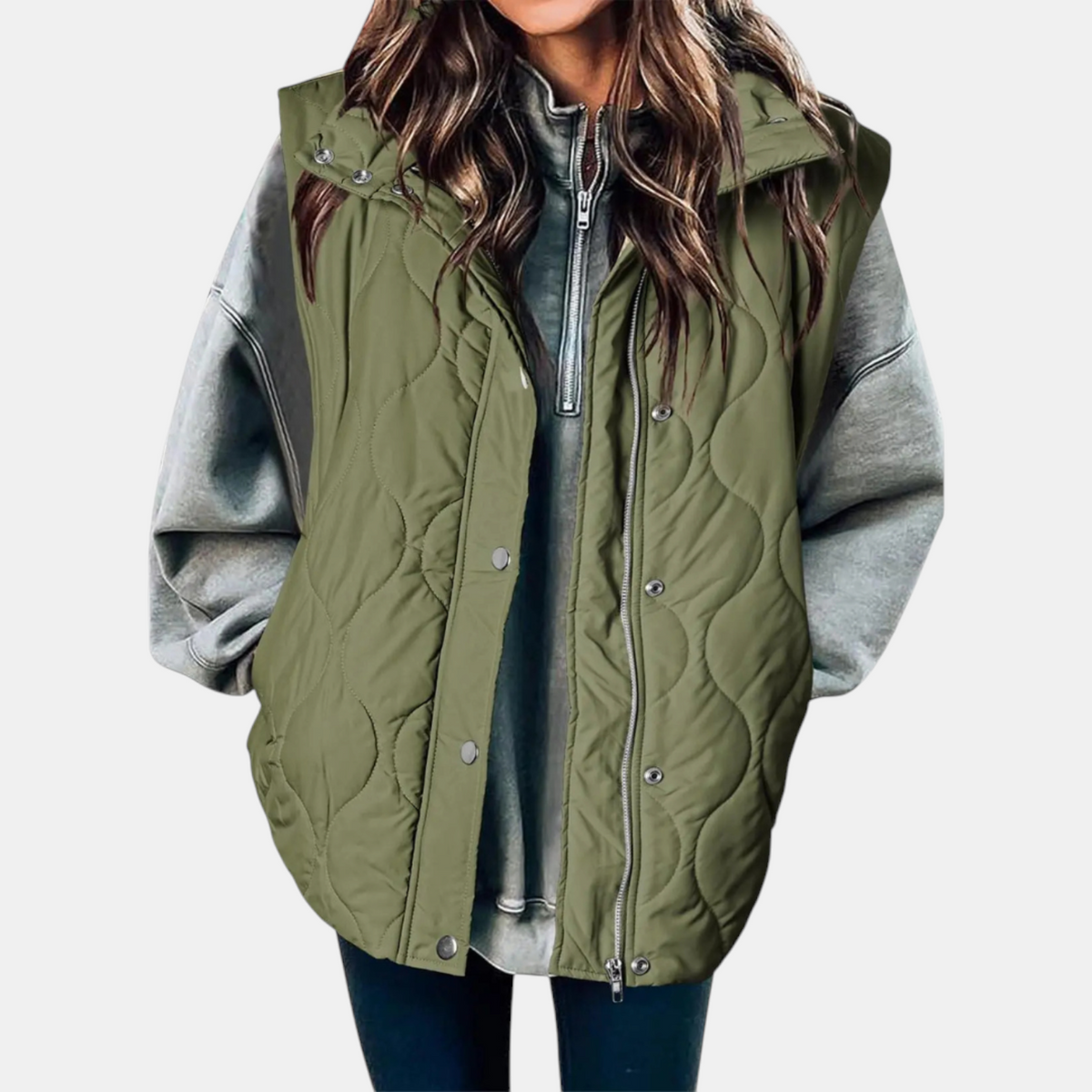 Olive green hooded longline puffer vest with wave quilting, layered over a grey sweatshirt.