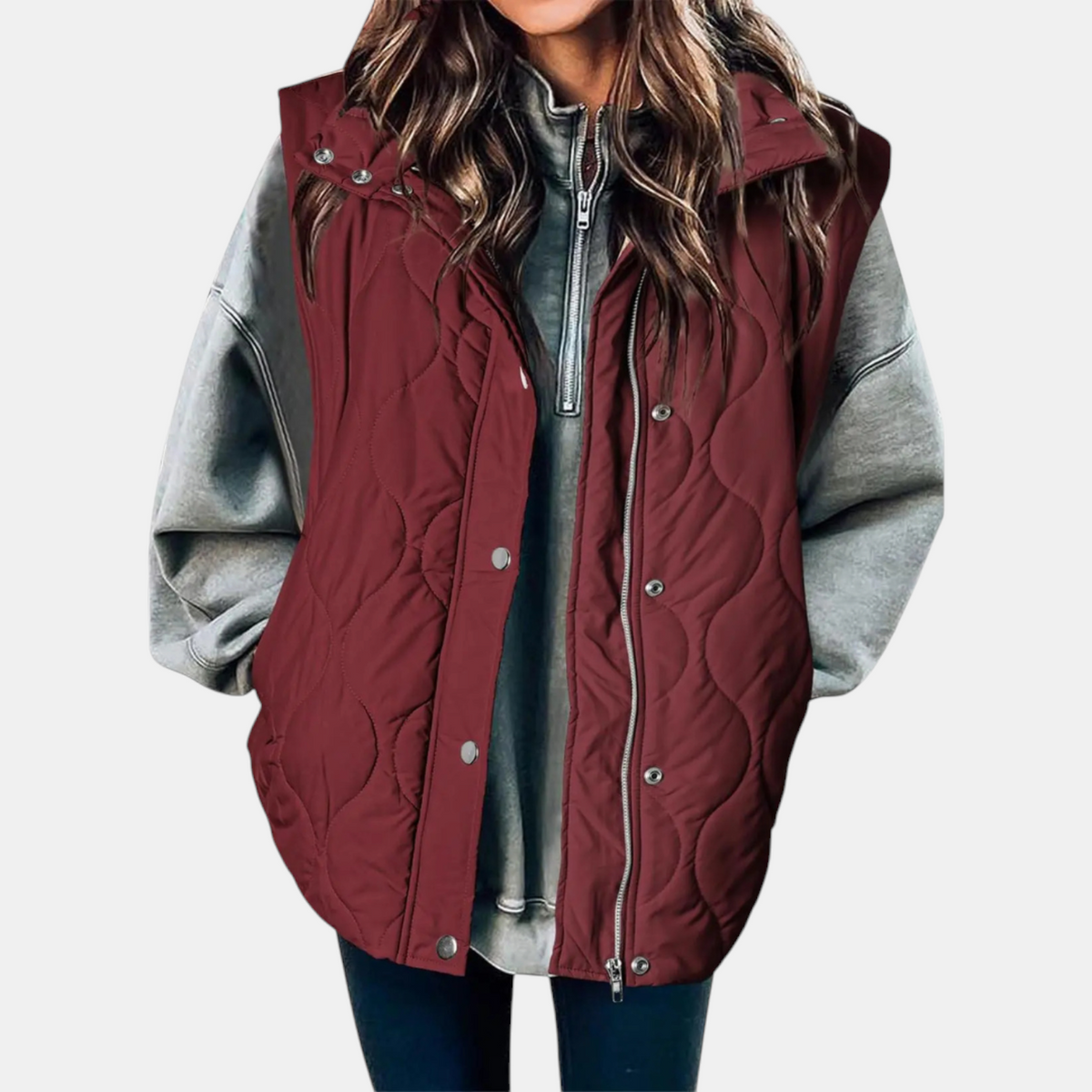 Burgundy longline puffer vest featuring a hood, wave quilting, and side pockets.