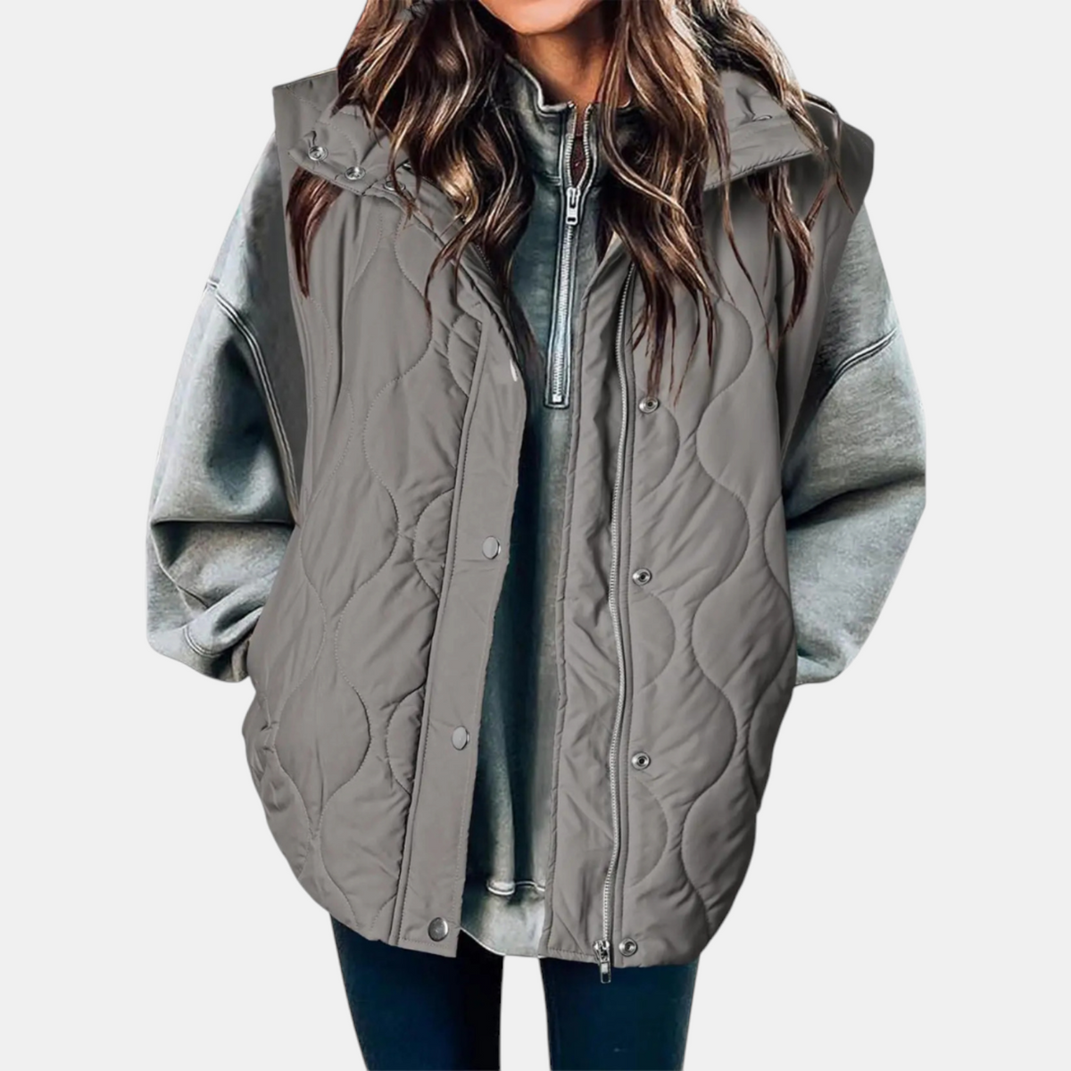 Grey quilted hooded puffer vest with curved wave stitching and a partially covered front zipper.
