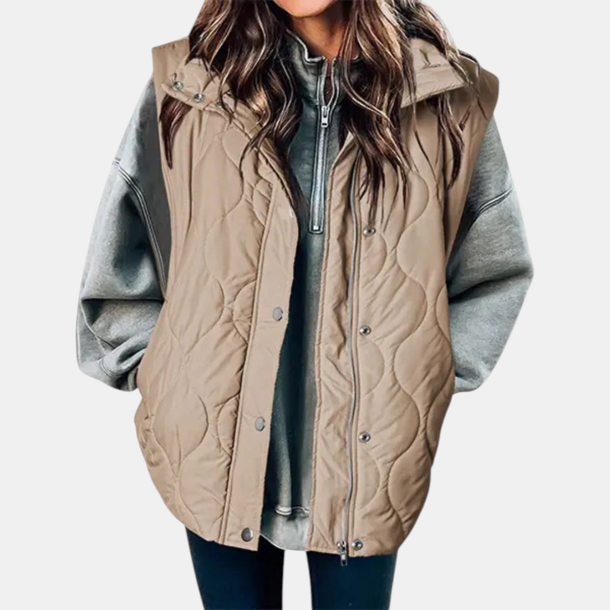 Taupe longline puffer vest with a hood, wave quilted texture, and snap-front detailing.