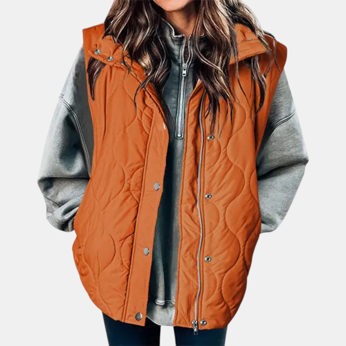 Orange hooded puffer vest with distinctive wave quilting and a long front closure.
