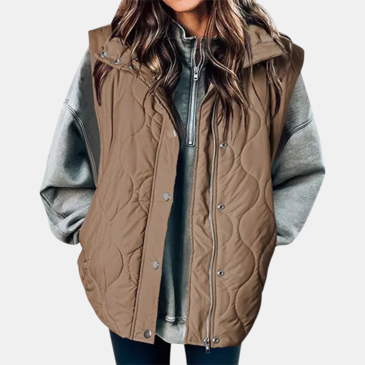 Brown quilted longline vest layered over casual clothing, with the hood and front fastening visible.