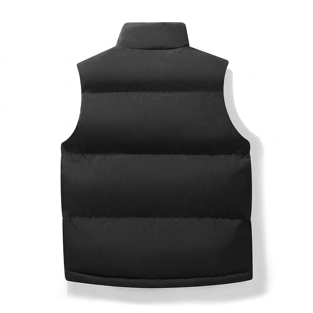 Back view of the black vest highlighting the broad sleeveless cut and three horizontal quilted sections.
