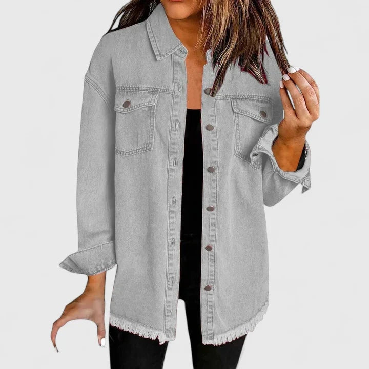 Gray trucker jacket with long sleeves, pointed collar, chest pockets, and a raw frayed hem shown without accessories.