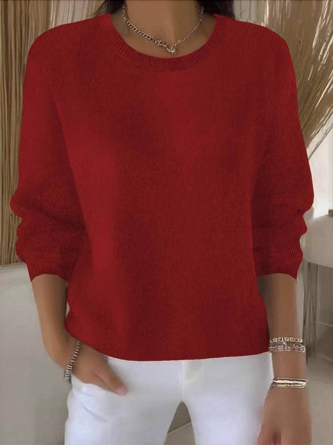 Red relaxed-fit crew neck sweater with rolled-up long sleeves, ribbed cuffs, and a curved ribbed hem.