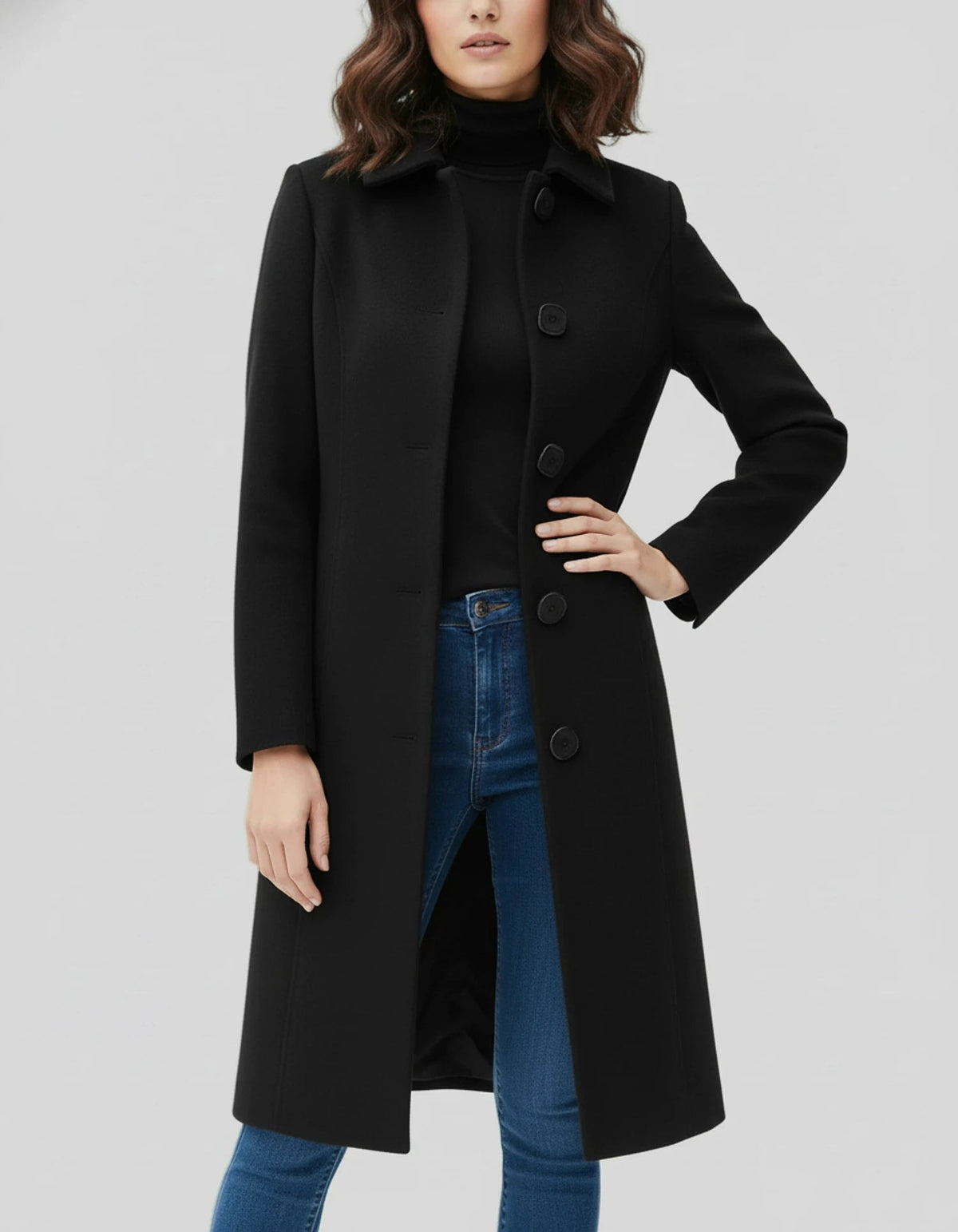 Black knee-length coat with a neat stand collar and buttoned front, shown with one hand on the waist to highlight its shaped silhouette.