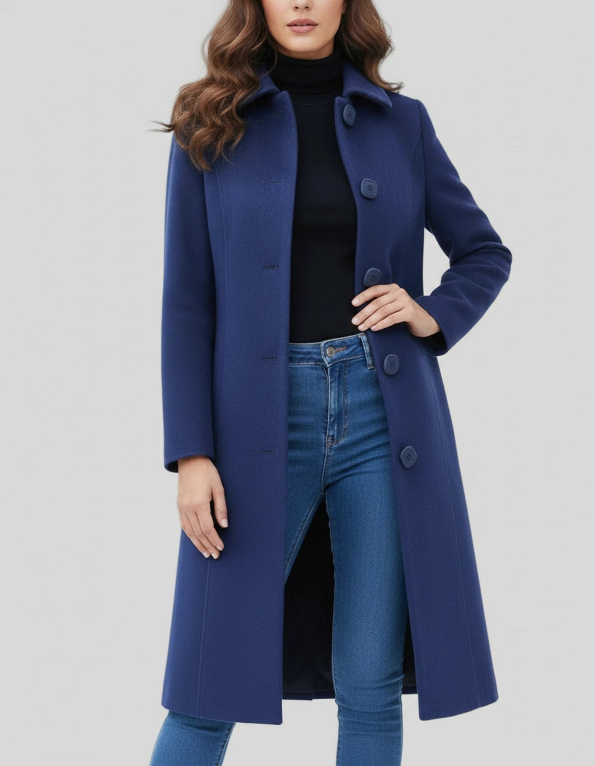 Blue knee-length coat with a buttoned front and stand collar, posed with one hand at the waist to show its fitted shape.