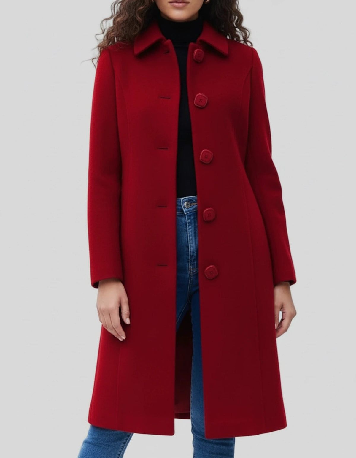 Red single-breasted knee-length coat with a stand collar, long sleeves, and a row of front buttons, worn over a black top and jeans.