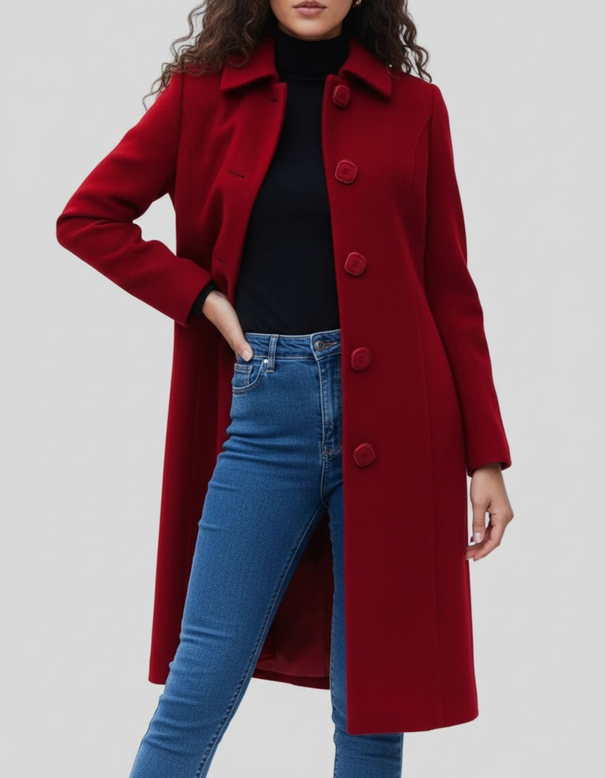 Red knee-length coat with a stand collar and buttoned front, shown in a relaxed pose that emphasizes its long sleeves and gently shaped waist.
