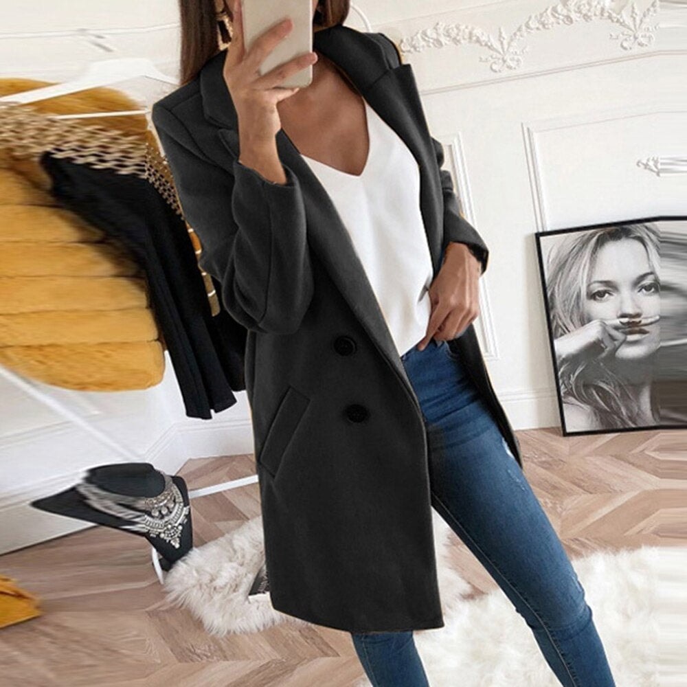 Black tailored coat with notch lapels and two dark buttons, shown open over a white top with angled hip pockets visible.