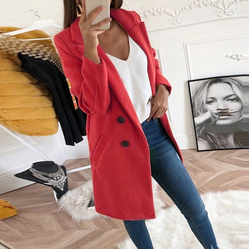 Red tailored coat showing a two-button front, classic notch lapels, long sleeves, and angled pockets over jeans.