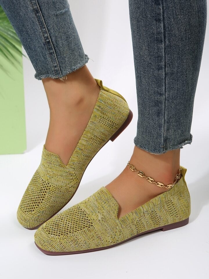 Yellow-green open-knit square-toe flats worn with cropped jeans, shown in a side-by-side angled view.