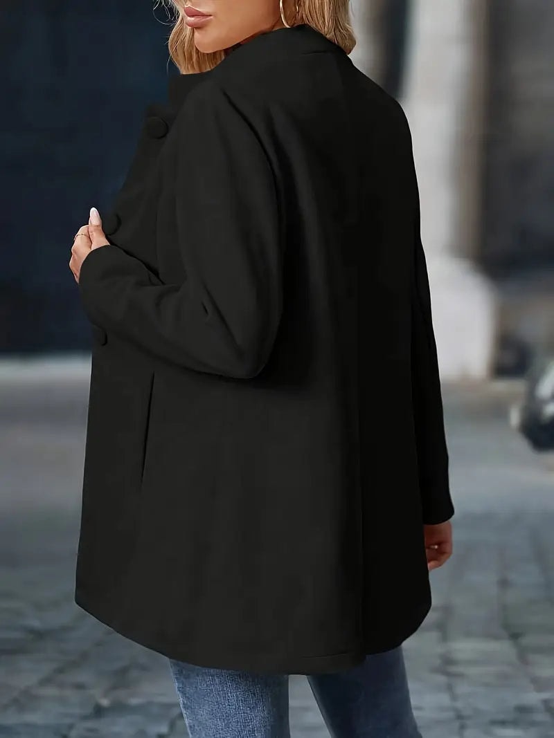 Rear three-quarter view of the black coat, highlighting its clean back and gently shaped hem.