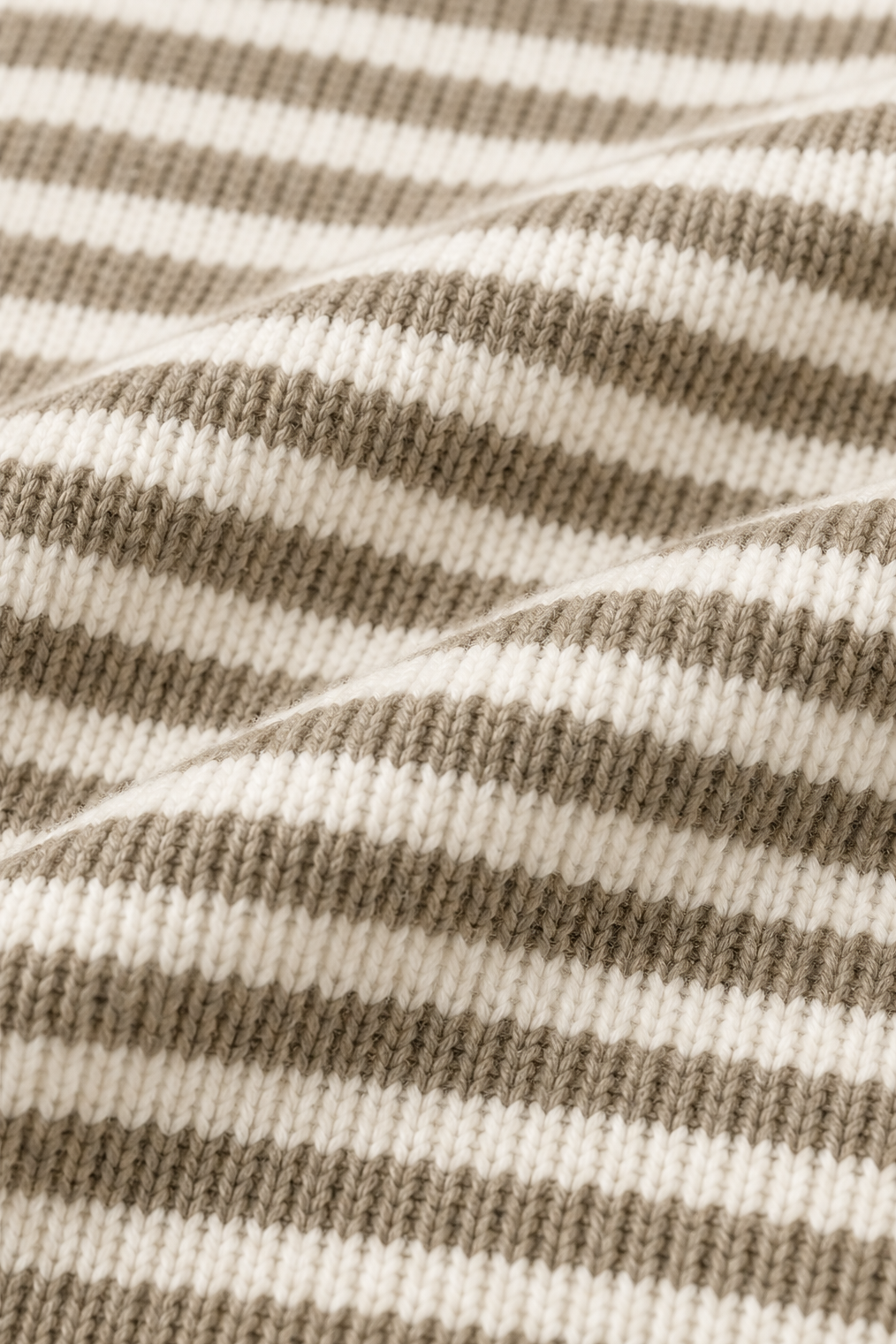 Close-up of the cardigan’s taupe-and-cream horizontal stripe pattern and textured knit surface.