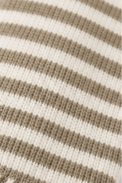 Macro view highlighting the cardigan’s alternating taupe and cream stripes and knit texture.