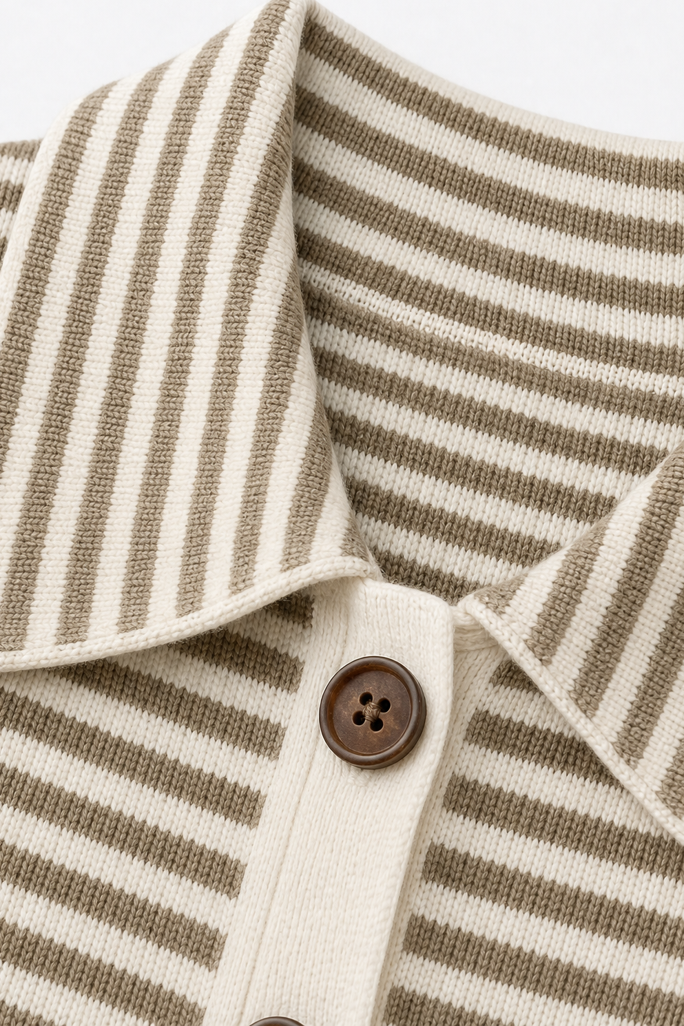 Close-up of the pointed striped collar, cream button placket, and brown button.