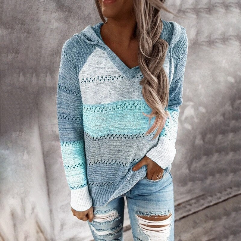 Blue, aqua, and cream striped openwork hooded sweater shown with jeans and long contrasting white cuffs.