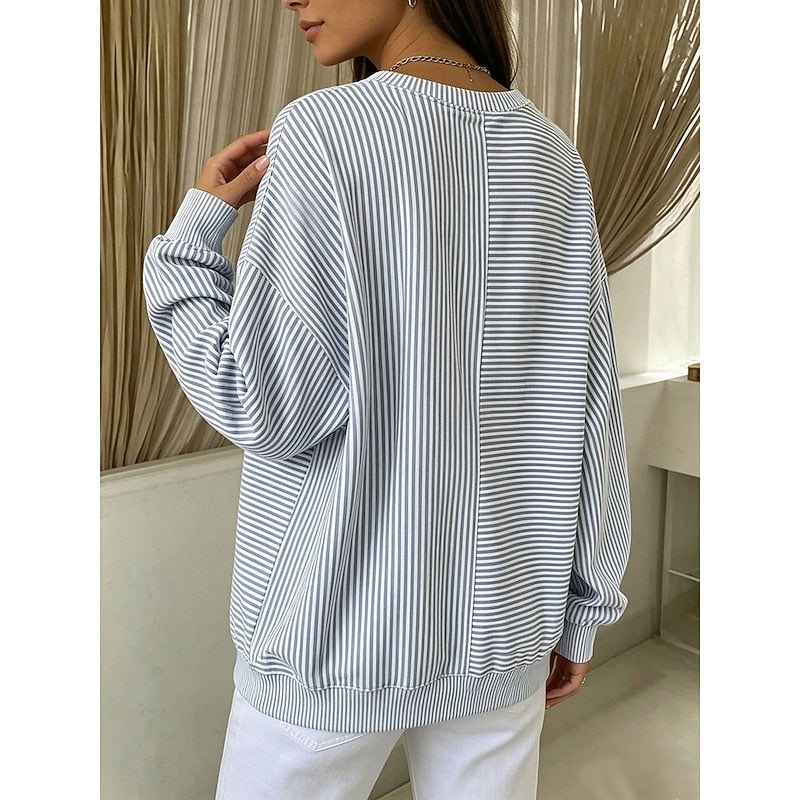 Back view of a relaxed-fit striped crew neck sweatshirt in light blue and white, showing mixed vertical and horizontal stripe directions, dropped shoulders, long sleeves, ribbed cuffs, and a ribbed hem.