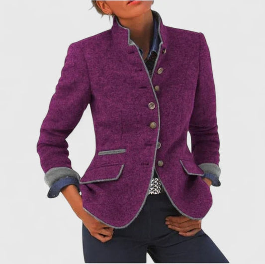 Purple tailored cardigan jacket with a stand collar, front buttons, contrast edging, turn-back cuffs, and flap pockets, shown on a model.