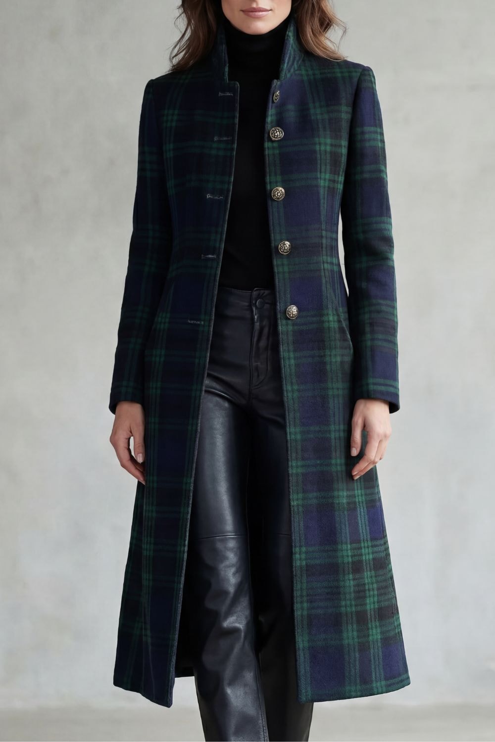 Front view of a woman wearing a dark tartan check longline coat with a stand collar, long sleeves, and front button closure.