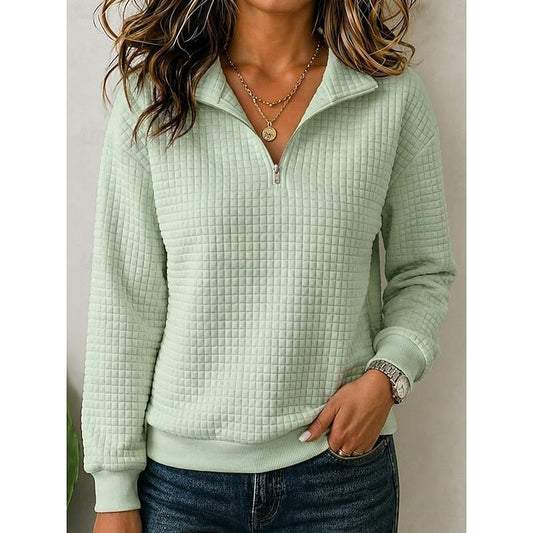 Front view of a pale green textured quarter-zip pullover with a fold-over stand collar, long sleeves, and ribbed cuffs and hem.