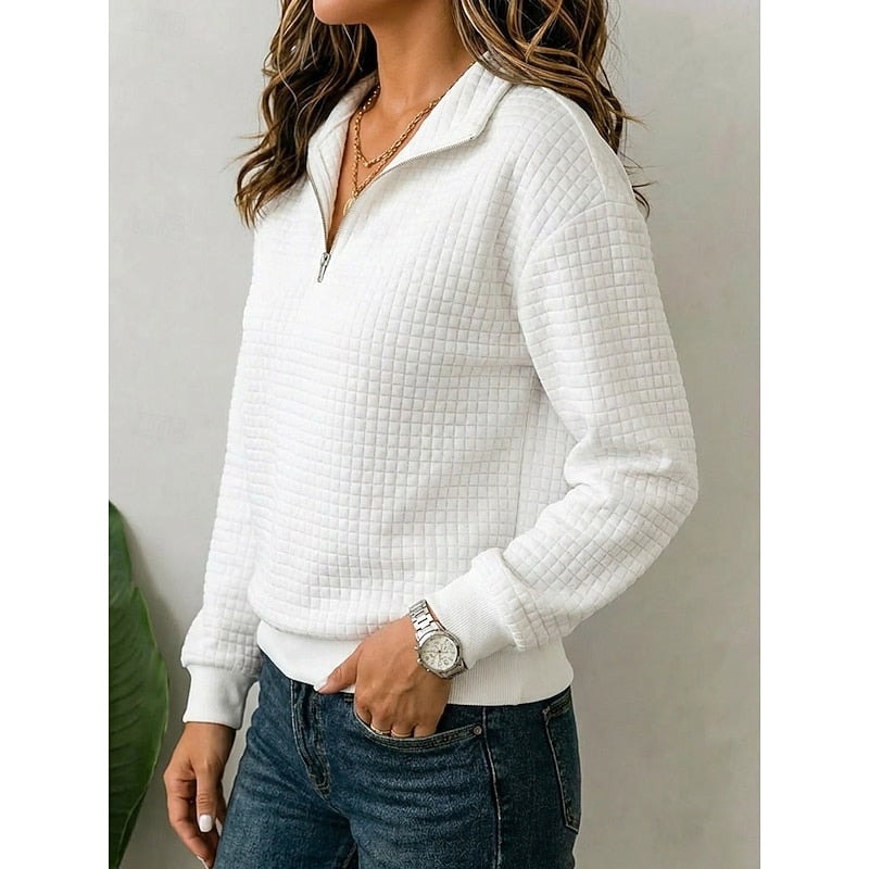 Side view of the white textured quarter-zip pullover, highlighting its stand collar, long sleeve, and ribbed hem.