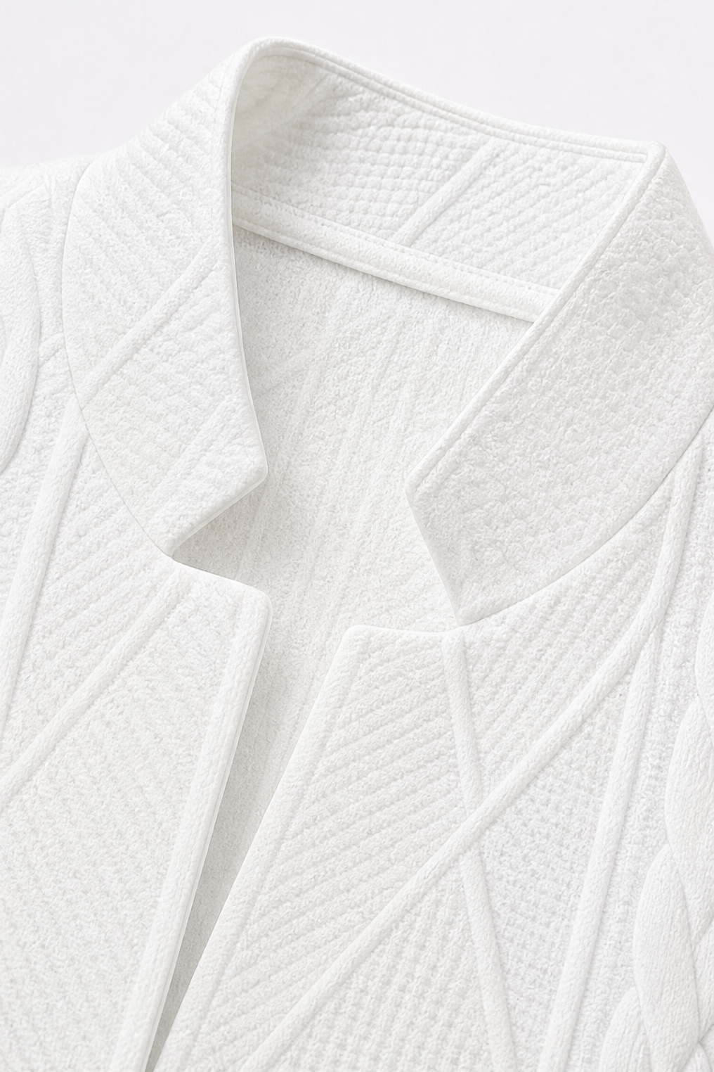 Close view of the blazer’s structured stand collar and geometric textured front panels.