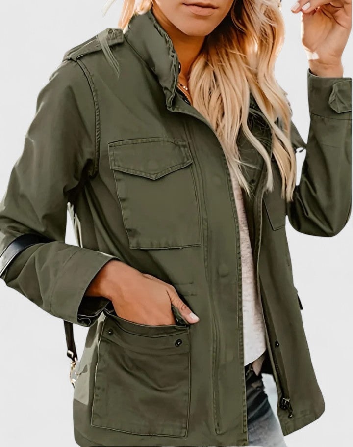 Olive utility jacket shown from the front with the high collar fastened, flap chest pockets, large lower pockets, and adjustable waist ties.