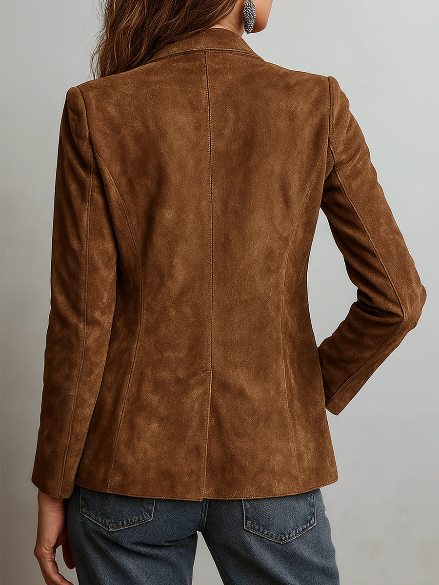 Back view showing the blazer’s clean tailored shape, center back seam, long sleeves, and hip-length hem.