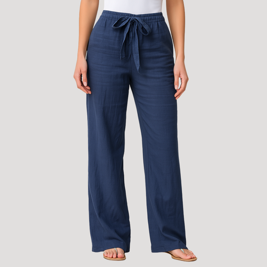 Navy blue wide-leg pants with a gathered elastic waist and long front drawstring, shown with flat sandals.