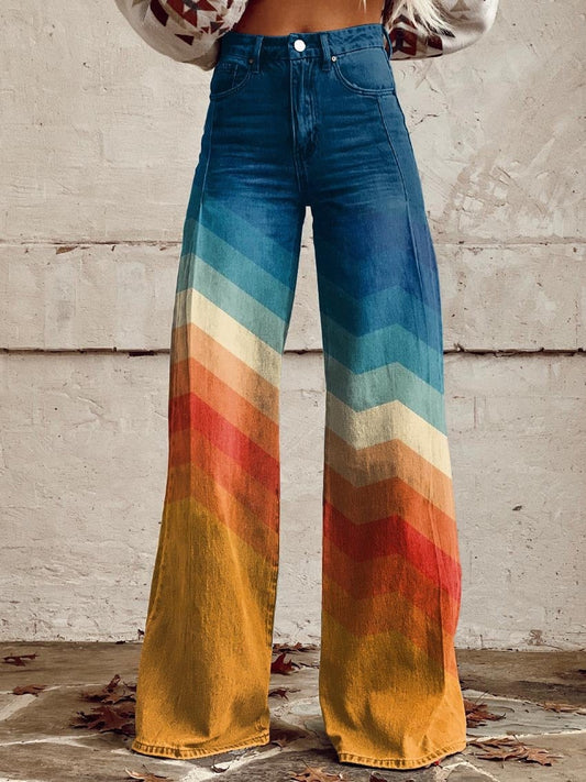 Front view of high-rise wide-leg pants with a blue denim-look upper section and colorful chevron bands continuing down the full-length legs to mustard-gold hems.